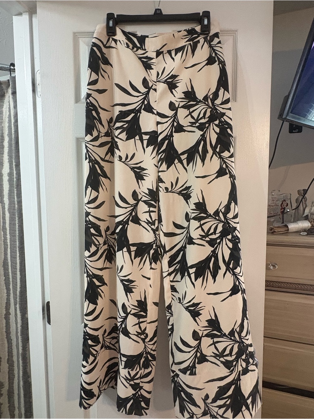 bebe Black Botanical Print Wide-Leg Pants on Cream